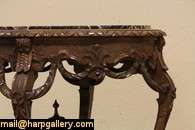 Carved of solid walnut about 1930, this small coffee table or 