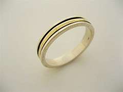   , modern, minimalistic design. Silver ring with spinning gold band