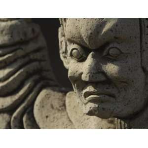  Close up of a Scowling Face Carved in Gray Stone Stretched 