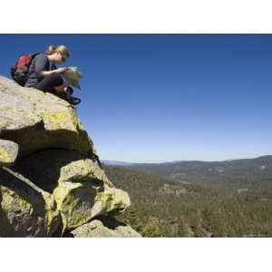  Female Hiker Reads a Map from Atop Jackass Peak Stretched 